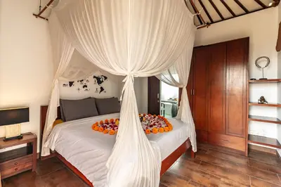 a bedroom with a canopy bed with fruit on it at PROMO Modern Seminyak Pvt Villa with Pool and Parking in Seminyak