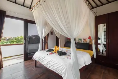 a bedroom with a bed with a canopy at PROMO Modern Seminyak Pvt Villa with Pool and Parking in Seminyak