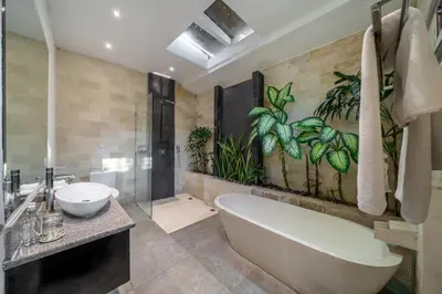 a bathroom with a tub and a sink at Villa Alchemy Private 4 BR Eat Street 10 steps to Revolver Cafe in Seminyak