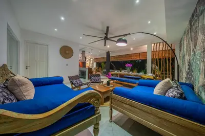 a large living room with blue couches at Villa Alchemy Private 4 BR Eat Street 10 steps to Revolver Cafe in Seminyak