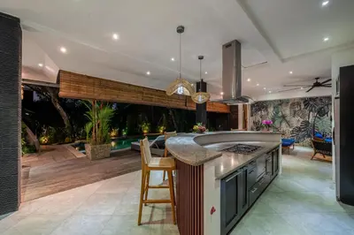 a kitchen with a kitchen island with a counter top at Villa Alchemy Private 4 BR Eat Street 10 steps to Revolver Cafe in Seminyak