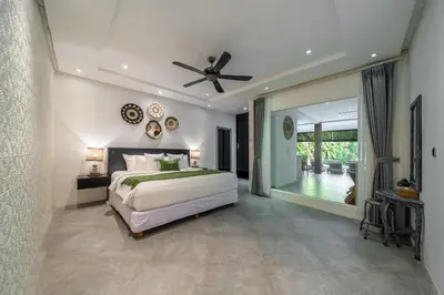 a bedroom with a bed and a ceiling fan at Villa Alchemy Private 4 BR Eat Street 10 steps to Revolver Cafe in Seminyak