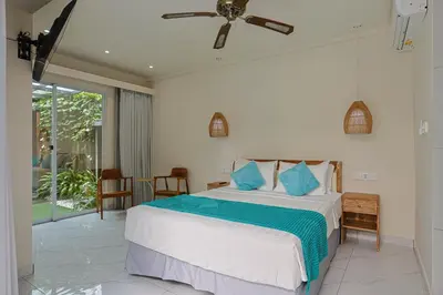a bedroom with a bed and a ceiling fan at Lacasa2 Villa Legian With Butler in Legian