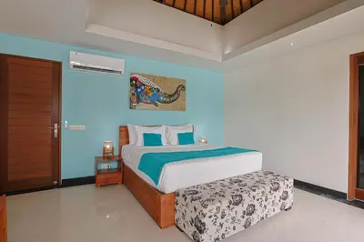 a bedroom with a bed with blue walls at Lacasa2 Villa Legian With Butler in Legian