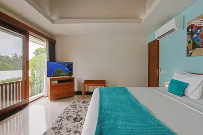 a bedroom with a bed and a flat screen tv at Lacasa2 Villa Legian With Butler in Legian