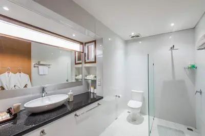 a white bathroom with a sink and a toilet at Lacasa3 Villa Legian With Butler in Legian