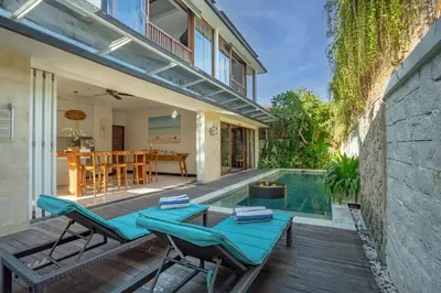 a backyard with a swimming pool and a house at Lacasa3 Villa Legian With Butler in Legian