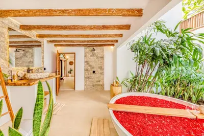 a bathtub in a bathroom with plants at Villa Indigo - 5-BDR with huge pool and garden in Seminyak