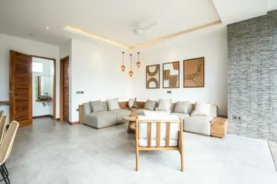 a living room with a couch and a table at Coastal Elegance 4BR Villa, 400m to Finns in Canggu