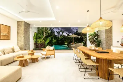 a living room with a table and a couch at Coastal Elegance 4BR Villa, 400m to Finns in Canggu