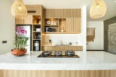 a kitchen with a stove and a sink at Coastal Elegance 4BR Villa, 400m to Finns in Canggu
