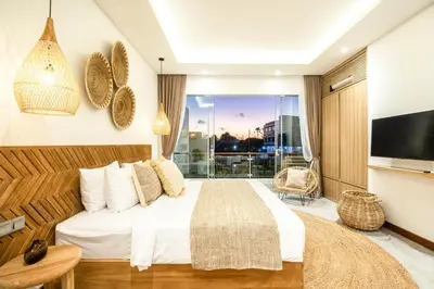 a bedroom with a large bed and a large window at Coastal Elegance 4BR Villa, 400m to Finns in Canggu
