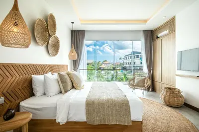 a bedroom with a large bed and a large window at Coastal Elegance 4BR Villa, 400m to Finns in Canggu