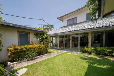 a house with a lawn in front of it at Villa Amana Seminyak in Seminyak