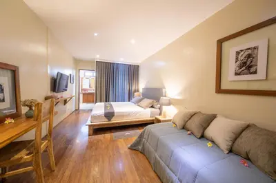 a bedroom with a bed and a couch in a room at Villa Amana Seminyak in Seminyak