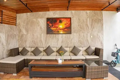 a living room with a couch and a table at Berawa Homestay in Canggu