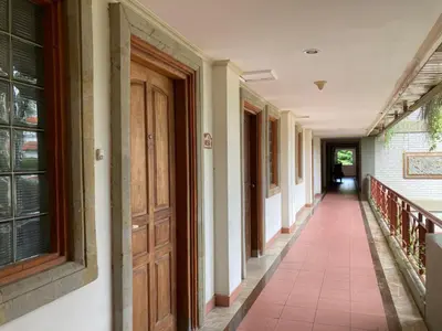 an empty hallway of a building with a door at Coastal Suite at Jayakarta Residence in Seminyak