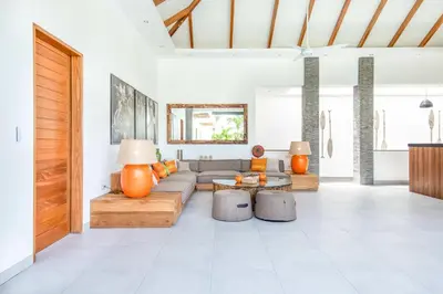 a living room with a couch and a table at Canggu 400m to Beach Escape 4br Designer villa in Canggu