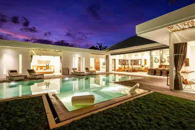 a villa with a swimming pool at night at Canggu 400m to Beach Escape 4br Designer villa in Canggu
