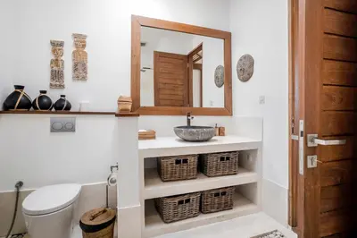 a bathroom with a sink and a mirror at Villa GoodFellas by BaliSuperHost in Seminyak