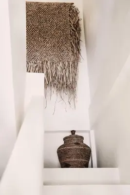 a vase sitting on a shelf in a white cabinet at Villa Obao in Seminyak