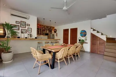 a kitchen and dining room with a table and chairs at Incredible 4BR Villa 5 mins walk to the beach in Canggu