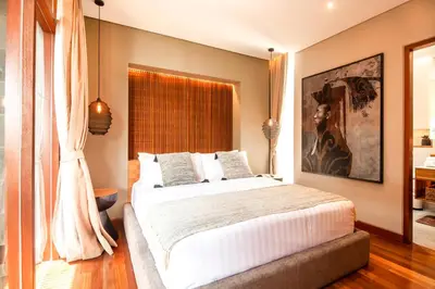 a bedroom with a large bed and a large window at Elegant 6BR Villa, Canggu, 400m to Finns Beach in Canggu