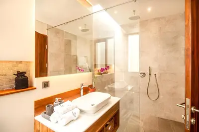 a bathroom with a sink and a shower at Elegant 6BR Villa, Canggu, 400m to Finns Beach in Canggu