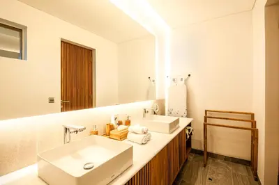 a bathroom with a white sink and a mirror at Marvelous 6BR, Panoramic Views, Ultimate Luxury in Canggu