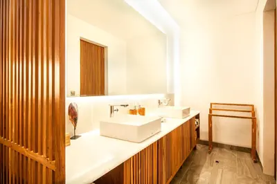a bathroom with a white sink and a mirror at Marvelous 6BR, Panoramic Views, Ultimate Luxury in Canggu