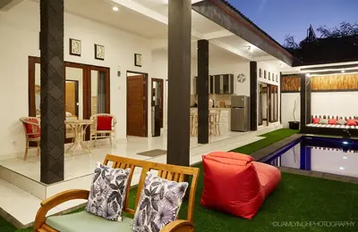 a living room with a pool and a house at Villa Kaya in Seminyak