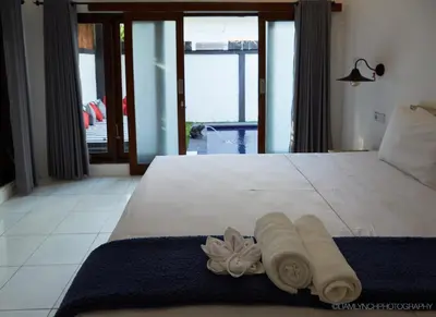 a bedroom with a bed with two towels on it at Massive 6-bedroom Villa with 2 Pools in Seminyak