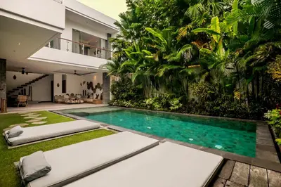a swimming pool in the middle of a house at Villa Ara by BaliSuperHost in Seminyak