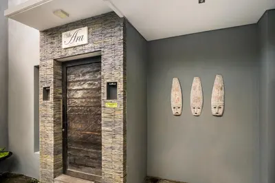 a room with a door and surfboards on the wall at Villa Ara by BaliSuperHost in Seminyak