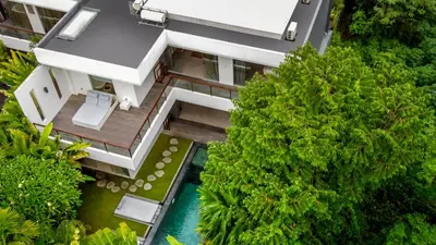 an aerial view of a house with a pool and trees at Villa Ara by BaliSuperHost in Seminyak