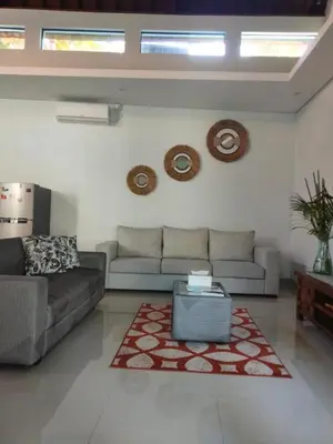a living room with a couch and a rug at Villa Bristol in Seminyak