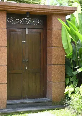 a wooden door on the side of a building at Villa Searenity Seminyak in Seminyak
