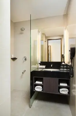 a bathroom with a sink and a mirror at Brits Hotel Legian in Seminyak