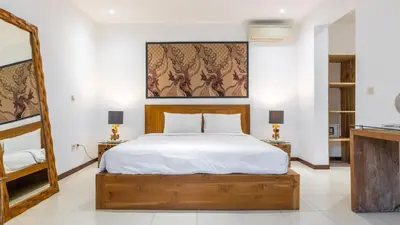 a bedroom with a large bed with white sheets at Large 6-Bedroom Private Villa with Pool for Groups & Families - Umalas in Kerobokan