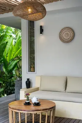 a coffee table on a patio with a couch at Villa Reina by SooBali - Spacious & Modern near Canggu with Butler-Cook, Private Pool and Tropical Gardens in Kerobokan
