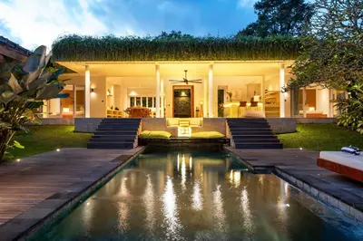 a house with a swimming pool in the yard at Villa Reina by SooBali - Spacious & Modern near Canggu with Butler-Cook, Private Pool and Tropical Gardens in Kerobokan