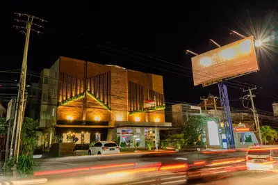 a busy city street at night with a building at Berry Biz Hotel Sunset Road in Seminyak