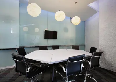 a conference room with a white table and chairs at Berry Biz Hotel Sunset Road in Seminyak