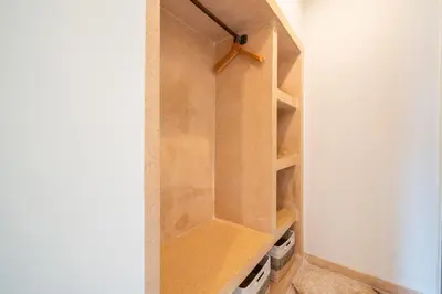 a closet with wooden shelves in a room at Villa Panchajanya - Seminyak in Seminyak