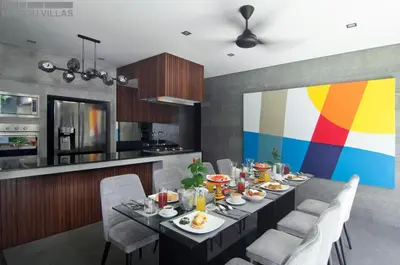 a dining room with a table with food on it at 8BR Villa Jumis - Minggu Villas Seminyak in Seminyak