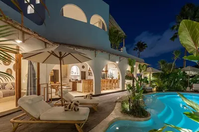 a villa with a swimming pool at night at Villa Lagertha by Optimum Bali Villas in Kerobokan