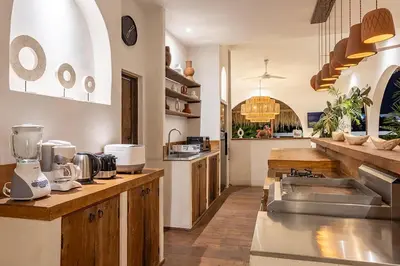 a large kitchen with wooden counters and a counter top at Villa Lagertha by Optimum Bali Villas in Kerobokan