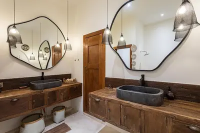 a bathroom with two sinks and a large mirror at Villa Lagertha by Optimum Bali Villas in Kerobokan
