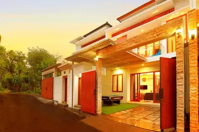 a facade of a house with a patio at Villa Noam By Bali Asia Villa in Jimbaran