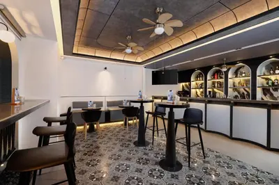 a restaurant with tables and chairs and a ceiling at The Mahata in Legian